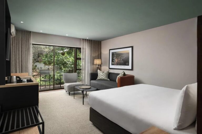 Ein Deluxe-Zimmer mit Balkon über dem Grün am Fluss