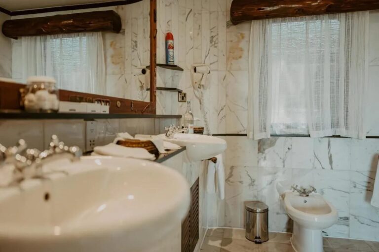 Ein Waschbecken in Nahaufnahme in einem Marmorbad, mit einem Bidet im Hintergrund